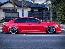 Load image into Gallery viewer, Red Holden Commodore VE Holden VE on air bag suspension kit slammed on the ground. Durable performance air struts front and rear. KS RACING Premium Air Suspension kit with KSPORT Air Struts.